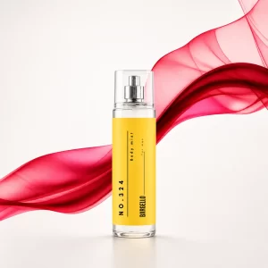 Bargello Body Mist 324 présenté dans un flacon jaune avec vaporisation visible, entouré d’amandes et d’éléments boisés sur un fond jaune doux. Pour femme.