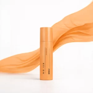 Déodorant 228 pour femme de Bargello présenté dans un filet réutilisable, entouré d’oranges fraîches et de brins de lavande, sur un fond orange lumineux.